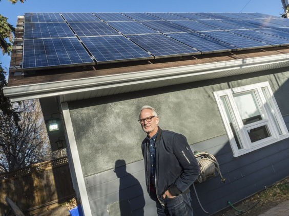 Stephen Hall stands in front of solar panels mounted to the roof his home studio. MICHAEL BELL/Regina Leader-Post